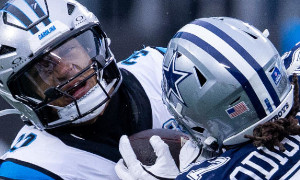 NFL players from the Carolina Panthers and the Dallas Cowboys battle for the ball
