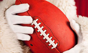 Santa hold a football and delivers a Xmas bonus